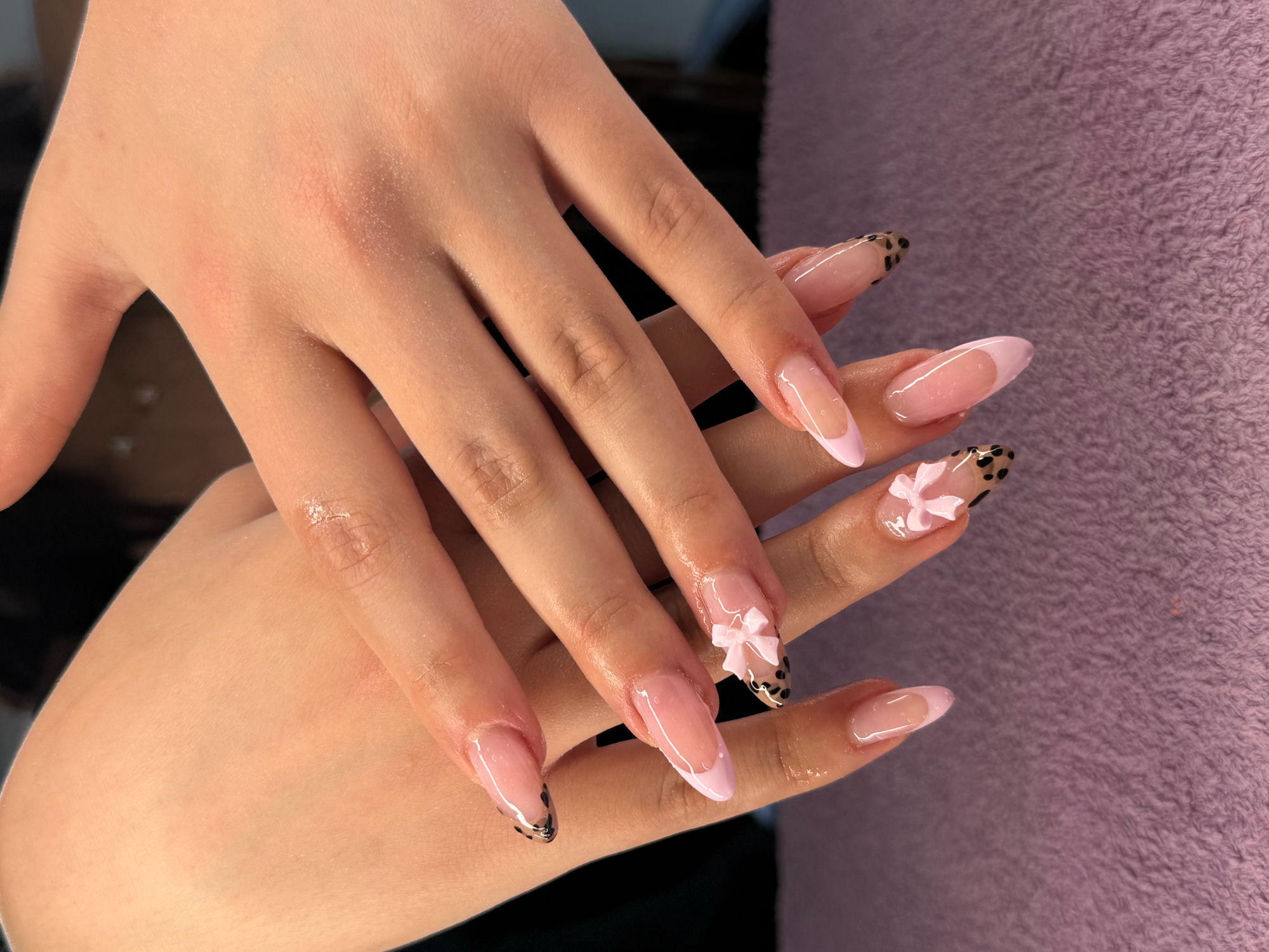 Soft pink French with leopard tips and 3D bows