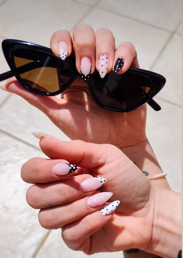 Pink and navy polka dot almond nails